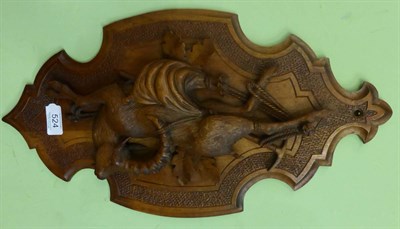 Lot 524 - A linden wood relief carved wall plaque, height 48cm