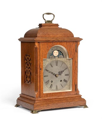 Lot 529 - An oak quarter striking table clock with a moonphase display, circa 1900, caddied top with carrying
