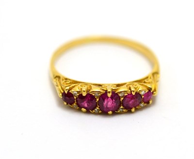 Lot 546 - # A ruby and diamond ring, five graduated mixed cut rubies with rose cut diamond accents, in yellow