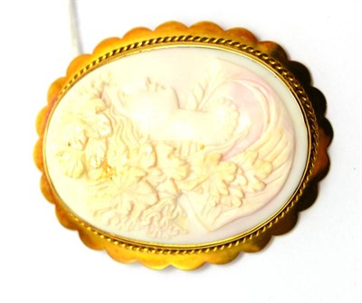 Lot 553 - A cameo brooch, depicting a Bacchante, within a rope twist decorated scalloped edge frame, measures