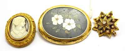 Lot 559 - # Three brooches, including; a pietra dura brooch with floral motif, measures 6cm by 4.8cm, a cameo