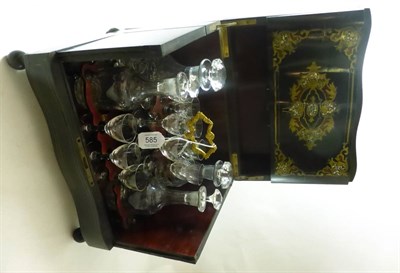 Lot 585 - A 19th century brass and mother-of-pearl inlaid ebonised tantalus containing a fitted interior...