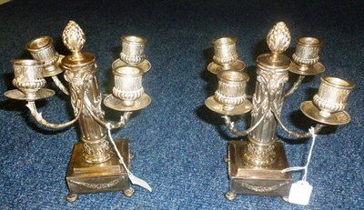 Lot 605 - A pair of continental white metal candelabra, marked crown over A, crown over interlaced C's,...