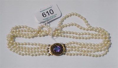 Lot 610 - # A cultured pearl choker, four rows of cultured pearls knotted to an oval cluster clasp with...