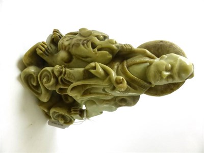Lot 611 - A Chinese soapstone figure of a scholar, 19th century, riding on the back of a lion dog, 22cm high
