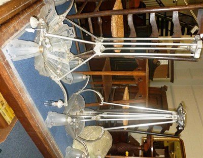 Lot 637 - Two French Art Deco silvered metal and frosted glass four-light chandeliers, each with moulded...