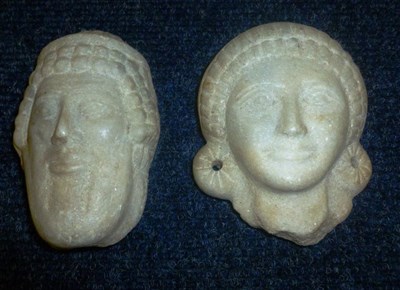 Lot 646 - A pair of carved Indian heads, height 12cm