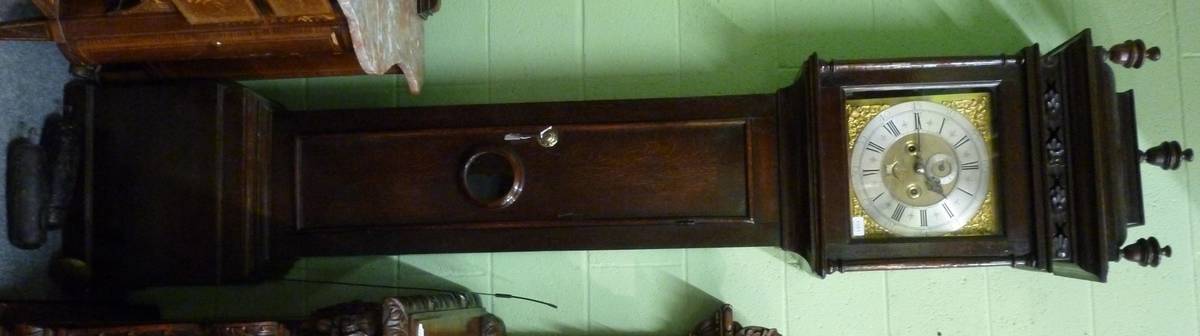 Lot 1551 - An oak eight day longcase clock, caddied pediment, moulded trunk door with a glazed lenticle,...