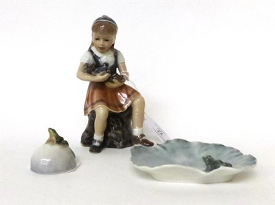 Lot 22 - * A Copenhagen figure of a girl with a teddy bear, 15cm; and two Royal Copenhagen ornaments moulded