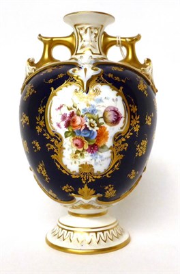 Lot 38 - * A Royal Worcester porcelain blue ground twin-handled vase, painted by E Phillips with a...