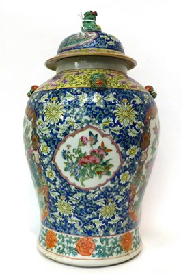 Lot 95 - * A Chinese porcelain jar and cover painted in famille rose enamels with birds in branches on a...