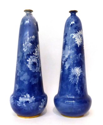 Lot 104 - * A pair of Doulton Burslem bottle vases decorated in blue with chrysanthemums, 39cm high