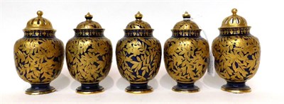 Lot 105 - * A matched set of three Royal Crown Derby porcelain blue ground jars and covers with gilt...