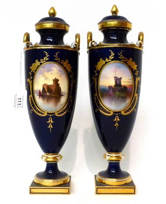 Lot 111 - * A pair of Minton blue ground twin-handled urn shaped vases and cover, painted by Dean with...