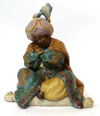 Lot 123 - * A Lladro bisque figure of a seated Persian gentleman, 28cm high