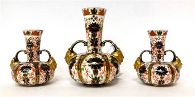 Lot 142 - * A garniture of three Crown Derby Imari pattern twin-handled bottle vases, 15.5cm and 11.5cm high