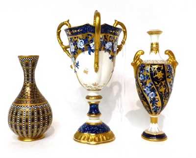 Lot 144 - * A Coalport triple-handled campana vase with blue and gilt decoration, 22cm high; a similar...