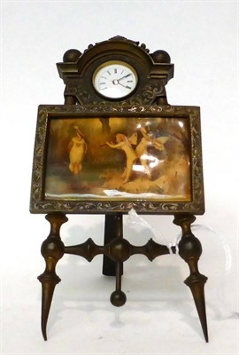 Lot 171 - * A picture easel form timepiece, early 20th century, central framed picture scene depicting winged