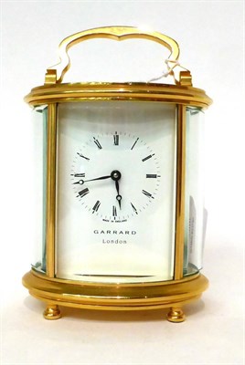 Lot 175 - * A brass oval shaped carriage timepiece, retailed by Garrard, London, 20th century, carrying...