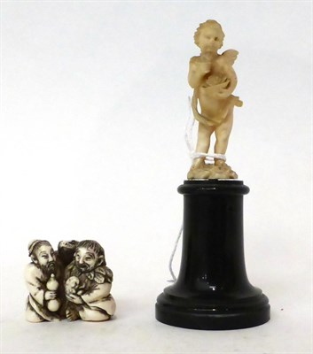 Lot 196 - * A Dieppe ivory figure of a putto, 19th century, holding a basket of flowers on a marble...