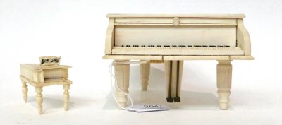 Lot 204 - * An ivory cased musical box, early 20th century, in the form of a grand piano, 15cm long; and...