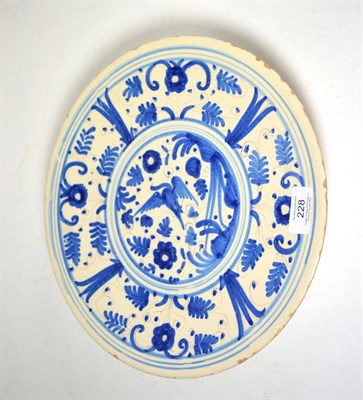 Lot 228 - A faience tazza, early 17th century, painted n blue with a bird in landscape within a panelled...