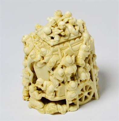 Lot 256 - A Meiji period Japanese ivory okimono, carved as numerous figures clambering over an elephant...