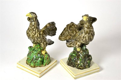 Lot 308 - A pair of Staffordshire pottery figures of Eagles, early 19th century, the naturalistically...