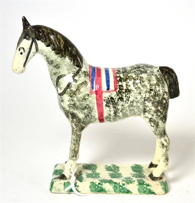 Lot 322 - A Pratt type pottery figure of a standing horse with sponged decoration, 18cm high