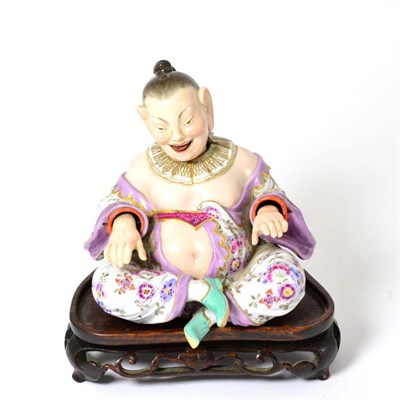 Lot 344 - A 19th century Meissen porcelain nodding head pagoda figure, 14cm high, and a hardwood stand