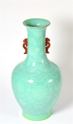 Lot 374 - A Chinese green glazed baluster vase with red mythical beast handles and foliate decoration, 32cm