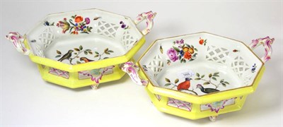 Lot 388 - A pair of faience yellow ground twin-handled baskets painted with birds in branches, 33cm wide