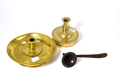 Lot 405 - A late 17th century candlestick, 12.5cm; a brass candlestick, 20cm; and a toleware snuffer, 21cm