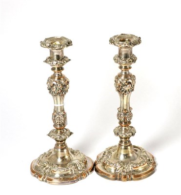 Lot 412 - A pair of Old Sheffield Plate candlesticks, chased with rococo style scrolls and shells