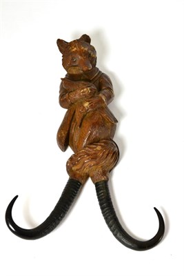 Lot 415 - A Blackforest fox coat hook, with antler horn branches