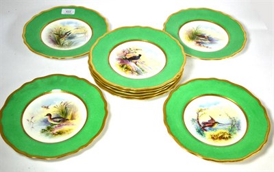 Lot 422 - Nine Wedgwood green ground cabinet plates each decorated with a central panel of birds, signed...