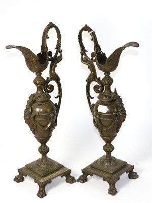 Lot 424 - A pair of bronzed spelter ewers in Renaissance style with cast figural handles, 47cm high