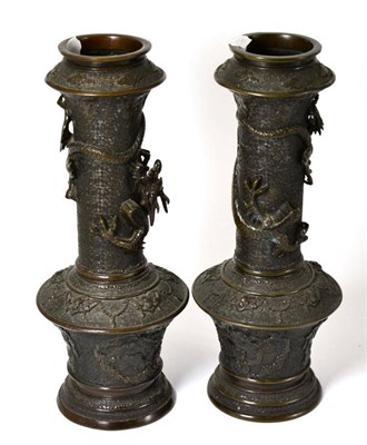 Lot 431 - A pair of 19th century Chinese bronze vases each cast with dragons in relief