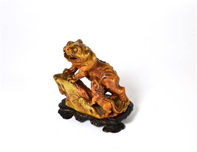 Lot 461 - A Chinese carved soapstone tiger and cub, Qing Dynasty, 1750-1850, 11cm high, with hardwood stand