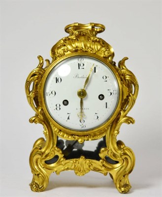 Lot 468 - An ormolu striking mantel clock, case with scroll decoration, side sound frets, carrying...