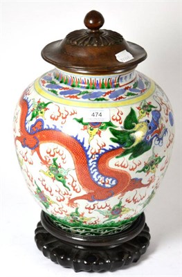 Lot 474 - # A Chinese Wucai baluster jar painted with dragons chasing the flaming pearl, bears Wanli...