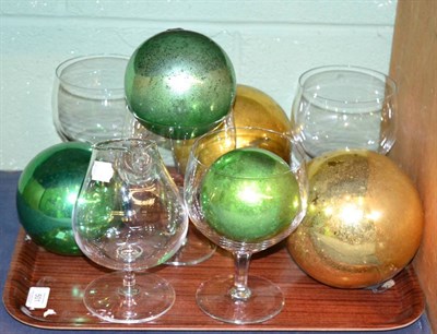 Lot 501 - ^ Five glass witches balls; a brandy warmer; and four large wine glasses