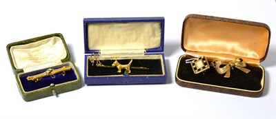 Lot 554 - Four brooches, including; a bar brooch with Scottie dog motif, a ruby and seed pearl set bar...