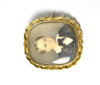 Lot 567 - An early Victorian portrait miniature on ivory, depicting a boy, bust length, wearing a dark...