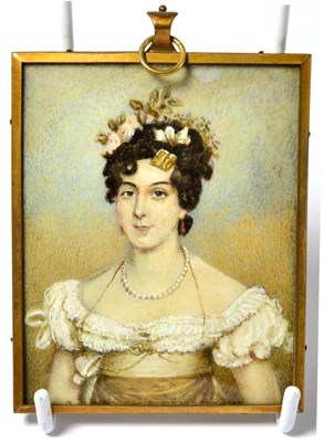 Lot 571 - An early 19th century rectangular portrait miniature on ivory, depicting a young woman, half...