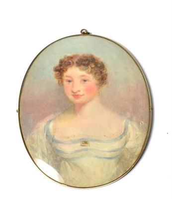 Lot 578 - An early 19th century oval portrait miniature on Ivory, depicting a young woman, half length,...