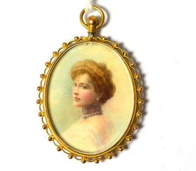 Lot 579 - An oval miniature pendant of a young lady, in a beaded frame with a locket back, measures 3cm...