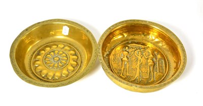 Lot 585 - A 17th century brass alms dish of circular form with repousse decoration, 24cm diameter and another