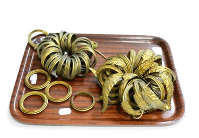 Lot 596 - A collection of 19th century gilded brass acanthus sheathed and other curtain rings...