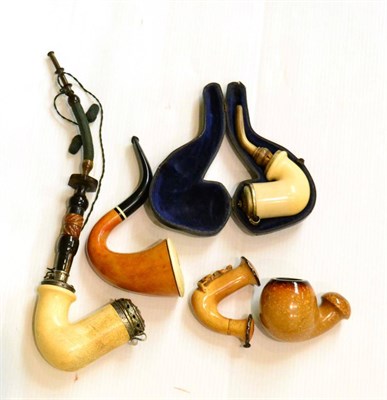 Lot 597 - A collection of four Meerschaum pipes and a Calabash